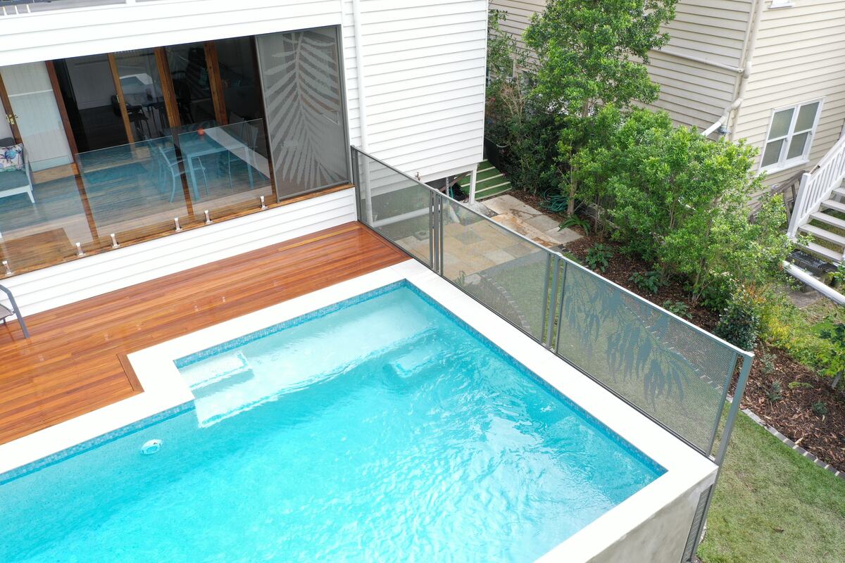 Gum design pool fencing in Textured Ironstone beside a bright pool, Queensland