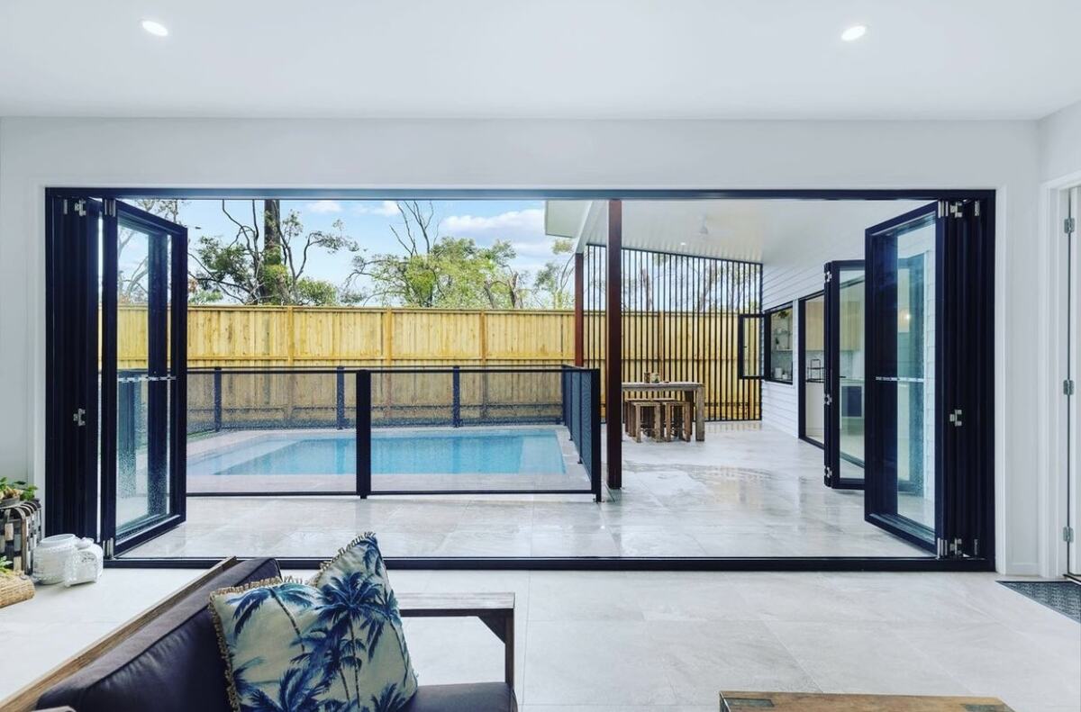 Pure Perf fenced pool seen through bifold doors, Queensland