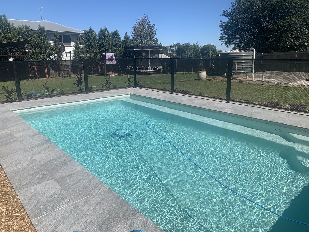 Pure Perf pool fencing in Textured Black around a large backyard pool, Queensland